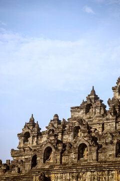 Low angle view of carvings on walls of Prambanan temple against sky