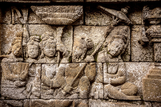 Human carvings on walls of Prambanan temple against clear sky
