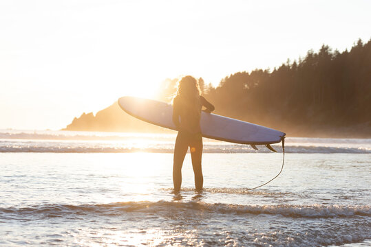 Surfer getting ready to head out into the ocean in Oregon