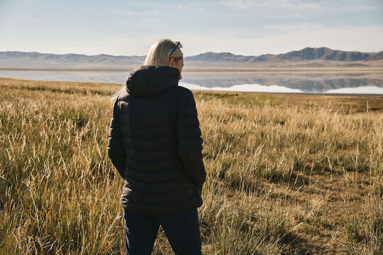 Girl traveler walks through the area near the lake TuzKol