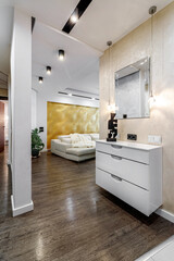 View of the living room and corridor in the modern apartment from the hallway