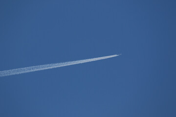 A plane and vapor trails in the sky