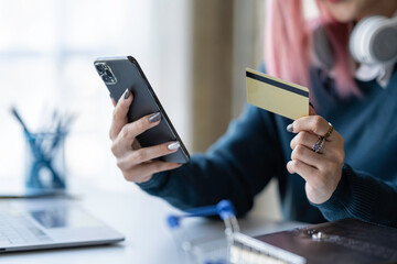 Young businesswoman using smartphone and credit card for online shopping online payment