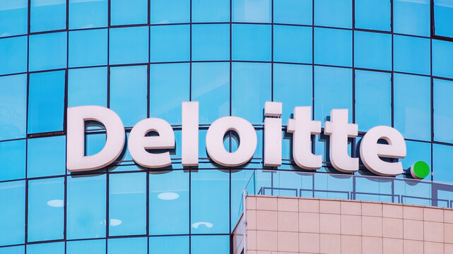 Minsk, Belarus - March 24, 2022: Deloitte sign on the glass facade of an office building