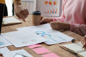 Teamwork with businessman analyzing cost graphs on table at conference room.