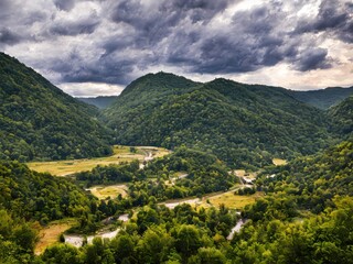 Fototapeta na wymiar Gorgeous mountain landscape with dark clouds Generative AI