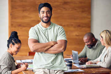 Portrait, business and man with arms crossed, success or professional with staff, planning or new project. Face, male leader or entrepreneur with smile, leadership skills or teamwork for advertising