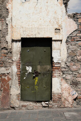 Building with a broken door and a sign that says the word on it, queretaro mexico