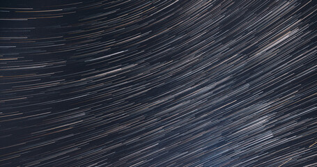 Fototapeta premium Hyper. Spin Of Unusual Amazing Stars Effect In Sky. Bewitching Illusion Of Star Trails. Meteors Trace On Night Dark Blue Sky Background. . Soft Colors. Rotate Of Sky Background