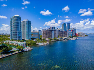 Coastline modern high-rise buildings at Miami South Channel in Miami Beach, Florida. Aerial view of modern city buildings against blue sky background.