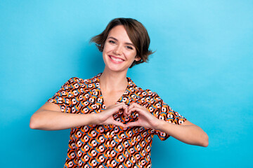 Photo of cute adorable woman wear print blouse showing arms heart chest empty space isolated blue color background