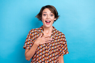 Portrait of astonished cute girl open mouth arm touch chest cant believe isolated on blue color background