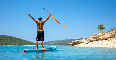 Happy man on stand up paddle board