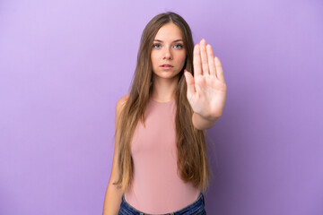 Young Lithuanian woman isolated on purple background making stop gesture