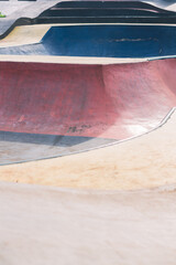 Empty skate park background with concrete bowl, rail and pump track
