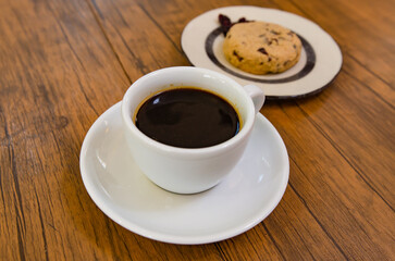 Coffee and cranberry cookies on a wooden table