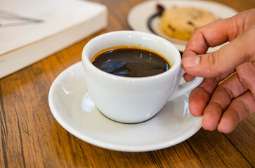 Coffee and cranberry cookies on a wooden table