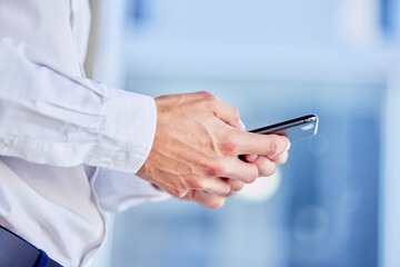 Hands, phone and texting with a business man in his office, closeup for communication or networking. Mobile, contact and internet with a male employee typing a text message or making a call