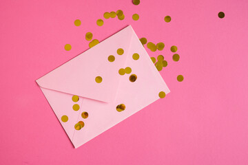 Pink paper envelope mockup on pink background. Flat lay, top view. Romantic love letter for Valentine's day concept.