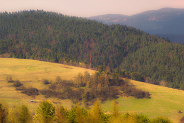 Lonely communication mast on slope in Beskid Mountains