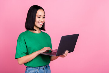 Portrait of cheerful cute woman straight hairstyle wear oversize t-shirt look at laptop distance meeting isolated on pink color background