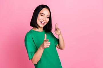 Photo of pretty positive nice girl with bob hairdo dressed green t-shirt directing at you blinking isolated on pink color background
