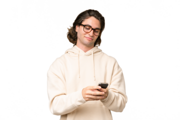 Young caucasian man isolated on green chroma background sending a message with the mobile