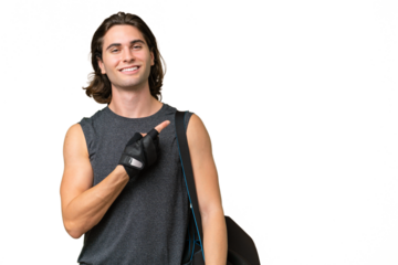 Young sport handsome man isolated on green chroma background pointing to the side to present a product