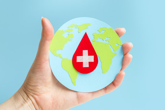 world hemophilia day. globe with blood drop paper cut, blood transfusion