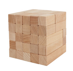 Wooden blocks toy made of natural wood stacked as cube isolated on white background. Childhood toys concept
