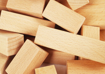 Wooden blocks toy made of natural wood stacked heap pile macro detail close up. Childhood toys concept