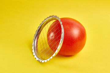 Vegetable slice and tomato on a yellow background. The concept of preparing dishes from vegetables.