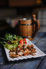 appetizer of small fried ribs on a white plate