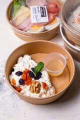 Breakfast cottage cheese with dried fruits top view. tomorrow in craft dishes