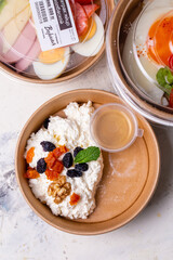 Breakfast cottage cheese with dried fruits top view. tomorrow in craft dishes