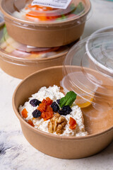 Breakfast cottage cheese with dried fruits top view. tomorrow in craft dishes