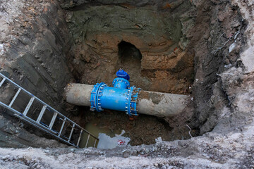 technical pit with a pipe, repair of underground utilities