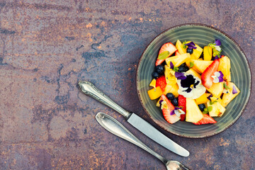 Salad of pansies and fruit, space for text