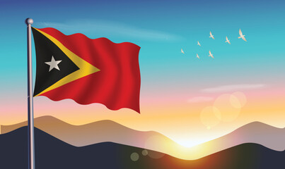East Timor flag with mountains and morning sun in background