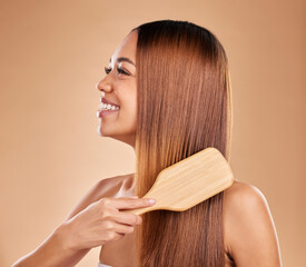 Beauty, woman and brush hair for growth and shine for straight texture on a brown background. Smile...