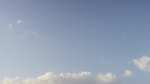 Camera tilts down from the sky above to the rolling waves of the Caribbean Sea below