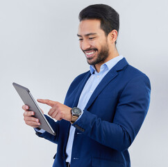 Smile, tablet and asian businessman in studio reading email, networking and internet on white...