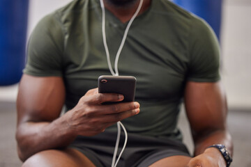 Phone, music and man hands in gym for workout, search social media and online training podcast. Closeup sports person, smartphone and listening with earphones on mobile, exercise app and connection