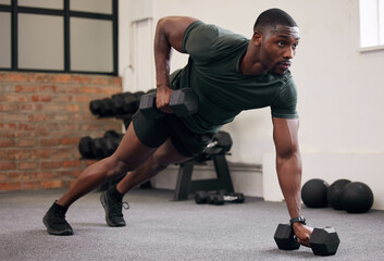 Black man, dumbbell row and training in gym, workout and strong fitness in health club. Serious...