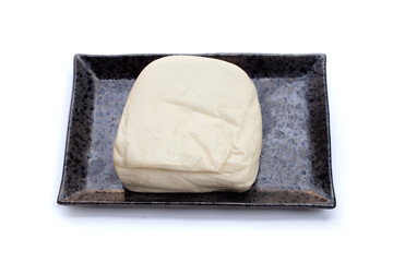 White tofu in black plate on white background
