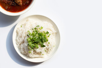 Rice noodles with Northern Thai pork curry in white plate on white background.