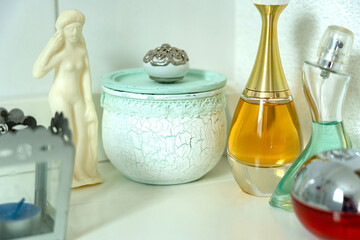 Beautiful vintage bath decoration of perfume bottles, candle and roman soap figure