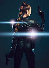Warrior, woman and gun to fight in studio for action or danger on dark background. Strong female...