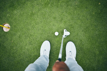Grass, golf hole and man with club on course for game, practice and training for golfing competition. Professional golfer, sports and top view of male shoes hit ball for winning, score or tee stroke
