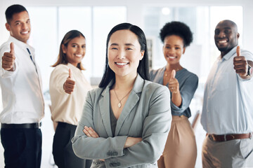 Fototapeta premium Asian woman, leadership and arms crossed, team and thumbs up, lead and professional mindset with collaboration. Diversity, teamwork and agreement, corporate group in workplace and smile in portrait